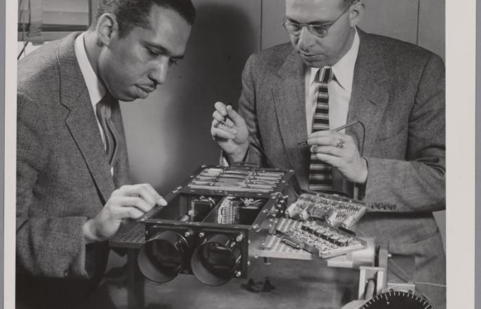John W. Brean and Martin Osman work on digital camera