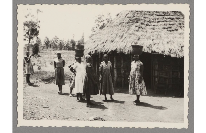 Kenyan women in front of hut, ca. 1965