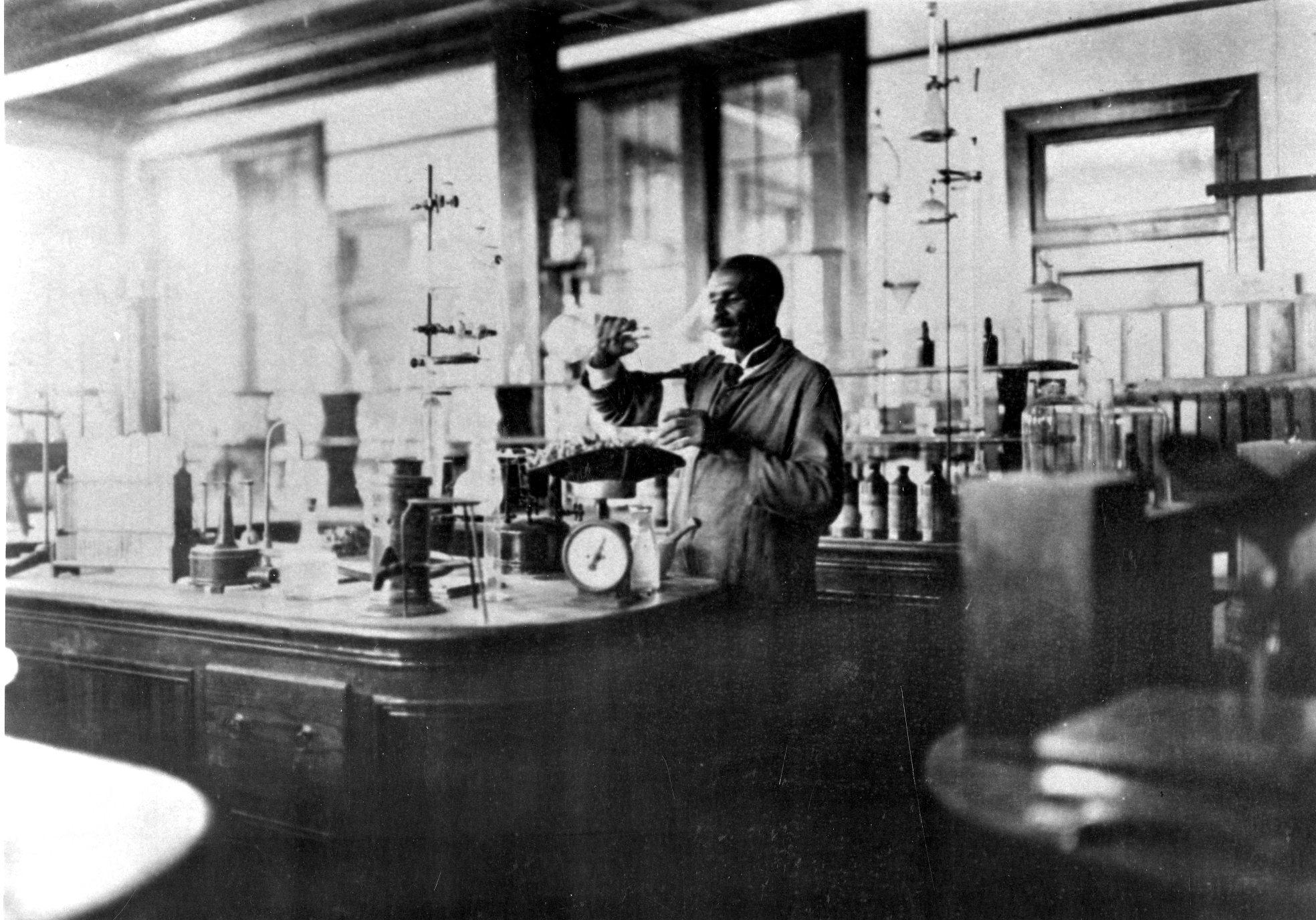 George Washington Carver at work in his laboratory